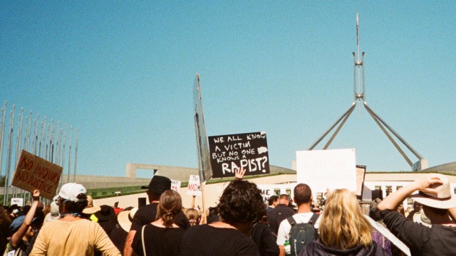protest signs at the front of parliament house at the march 4 justice